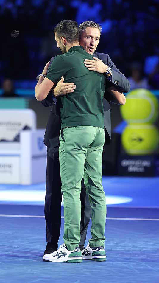 ATP Chairman Andrea Gaudenzi embraces year-end No. 1 Novak Djokovic.